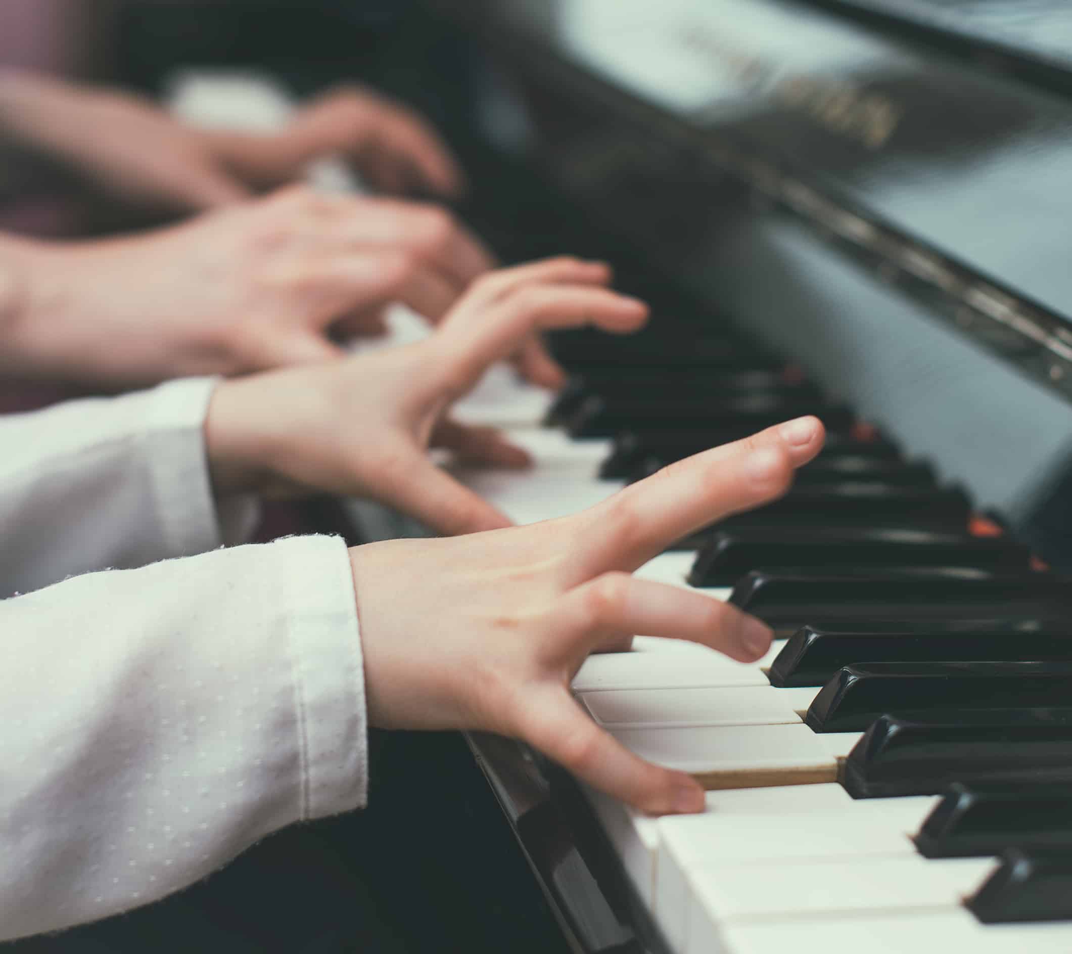 Child learning to play the piano